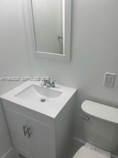 1680 Northeast 5th Street Homestead, FL 33033 - Photo 17 of 26 a bathroom with a sink a toilet and mirror