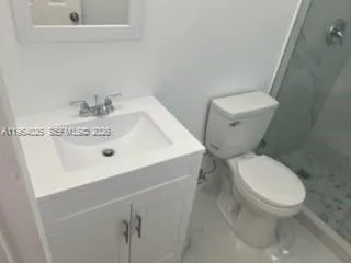 a white toilet sitting next to a bathroom sink