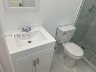 1680 Northeast 5th Street Homestead, FL 33033 - Photo 18 of 26 a white toilet sitting next to a bathroom sink