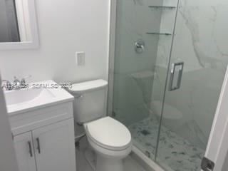 1680 Northeast 5th Street Homestead, FL 33033 - Photo 25 of 26 a bathroom with a sink a toilet and shower