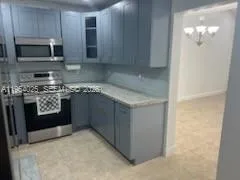 a kitchen with stainless steel appliances granite countertop a stove a microwave and cabinets