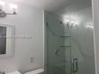 a bathroom with a shower and toilet