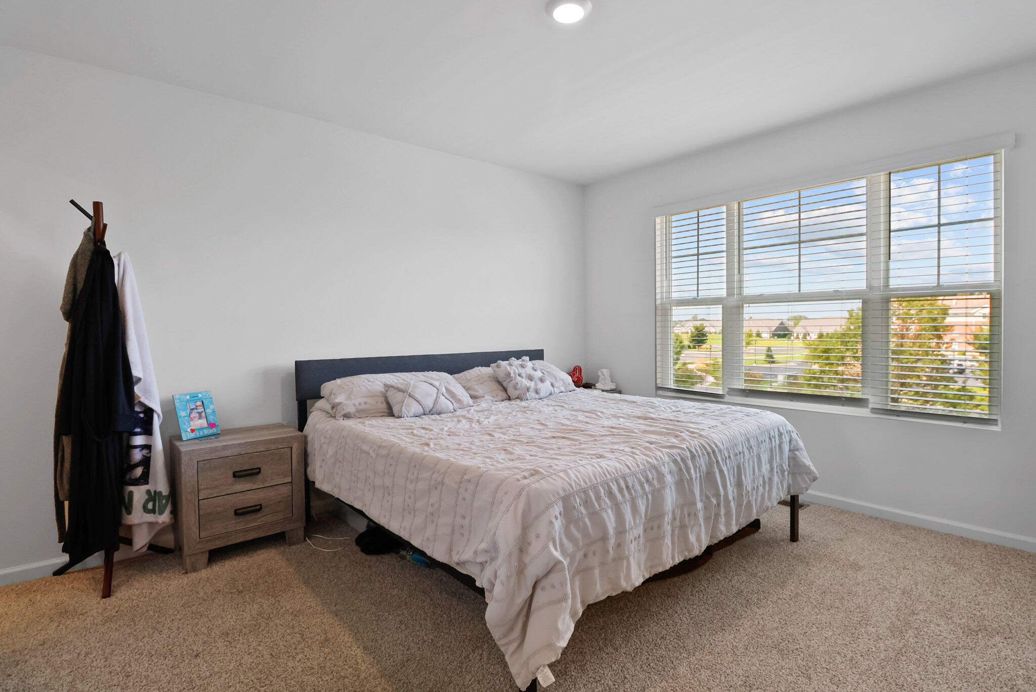 10743 Violette Way St. John, IN 46373 - Photo 17 of 23 a bed sitting in a bedroom next to a window
