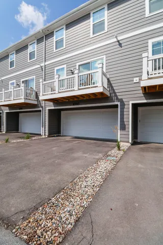 a front view of a house with a road