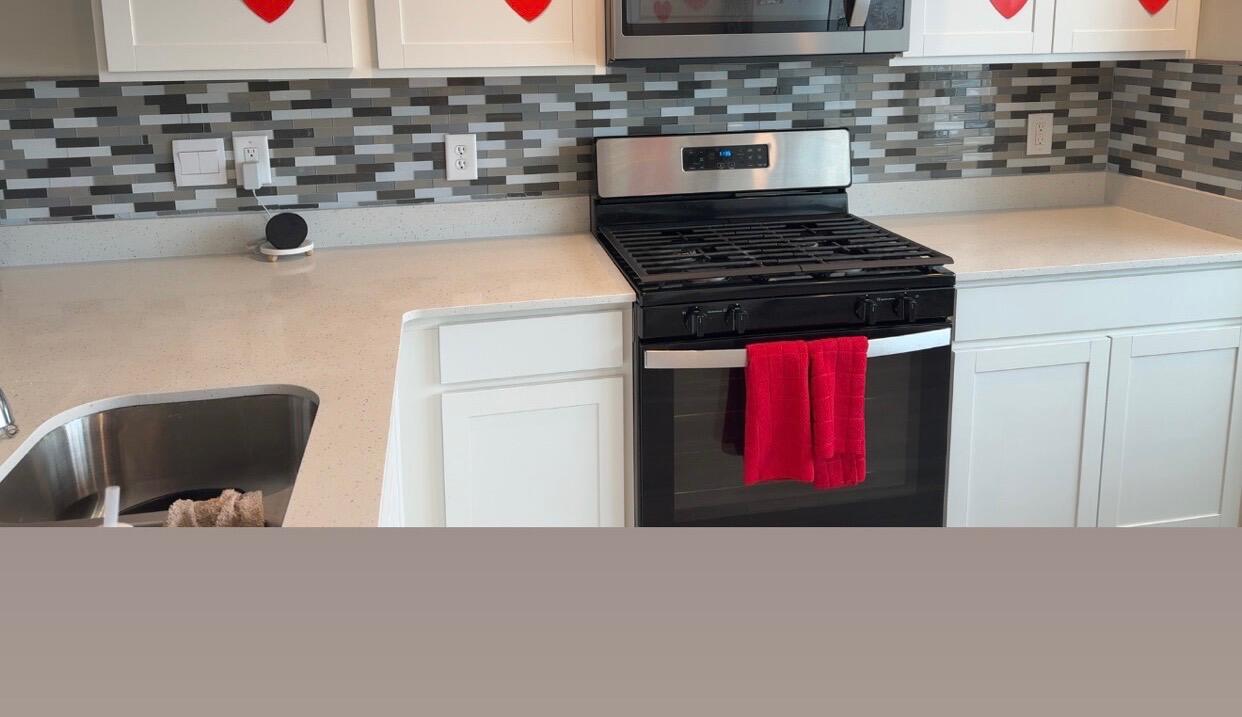 10743 Violette Way St. John, IN 46373 - Photo 6 of 23 a kitchen with a stove and a refrigerator