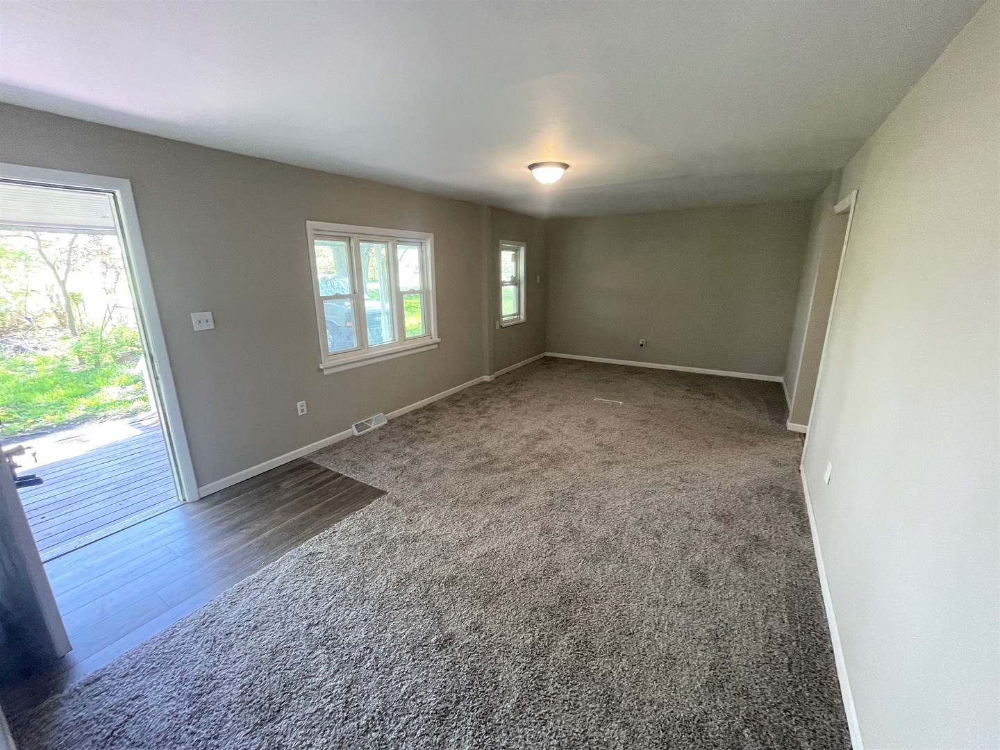 1119 New Lenox Road Joliet, IL 60433 - Photo 2 of 10 an empty room with wooden floor and windows