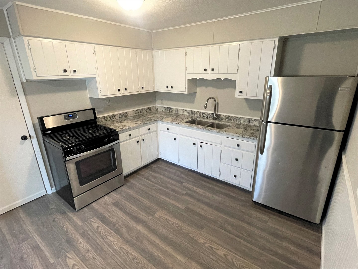 1119 New Lenox Road Joliet, IL 60433 - Photo 3 of 10 a kitchen with granite countertop white cabinets and white appliances