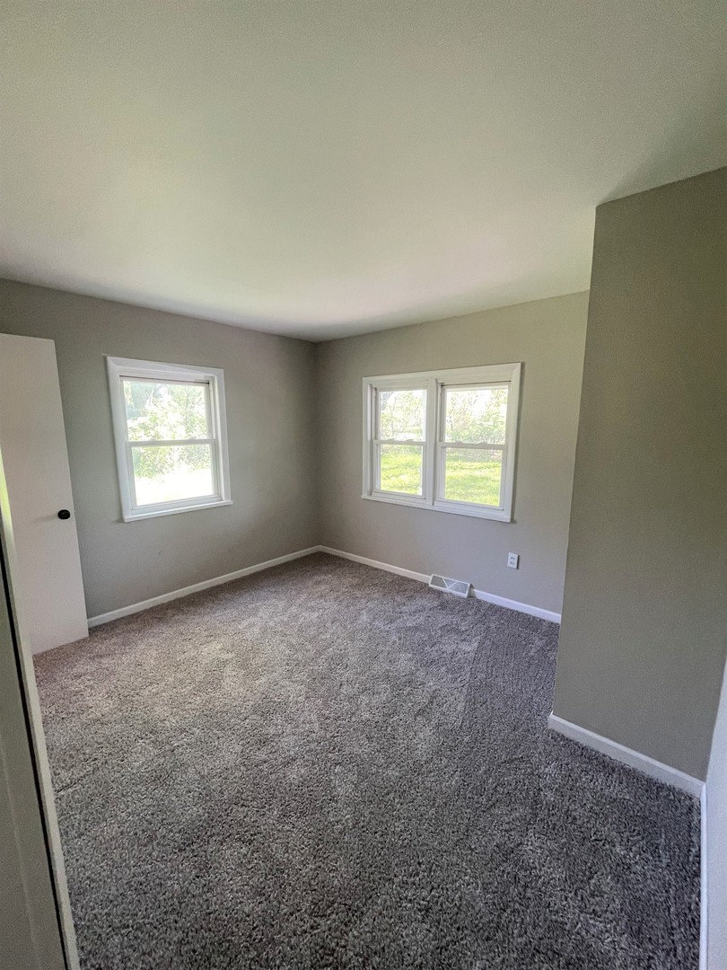 1119 New Lenox Road Joliet, IL 60433 - Photo 5 of 10 an empty room with windows