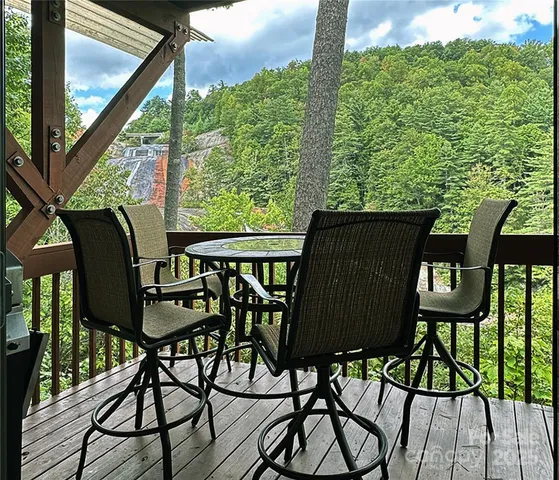 a view of balcony with wooden floor and outdoor seating