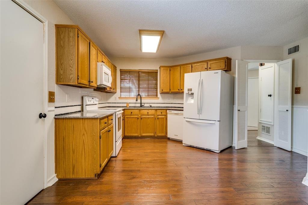 6804 Century Circle Plano, TX 75023 - Photo 5 of 13 a kitchen with stainless steel appliances a refrigerator sink and cabinets