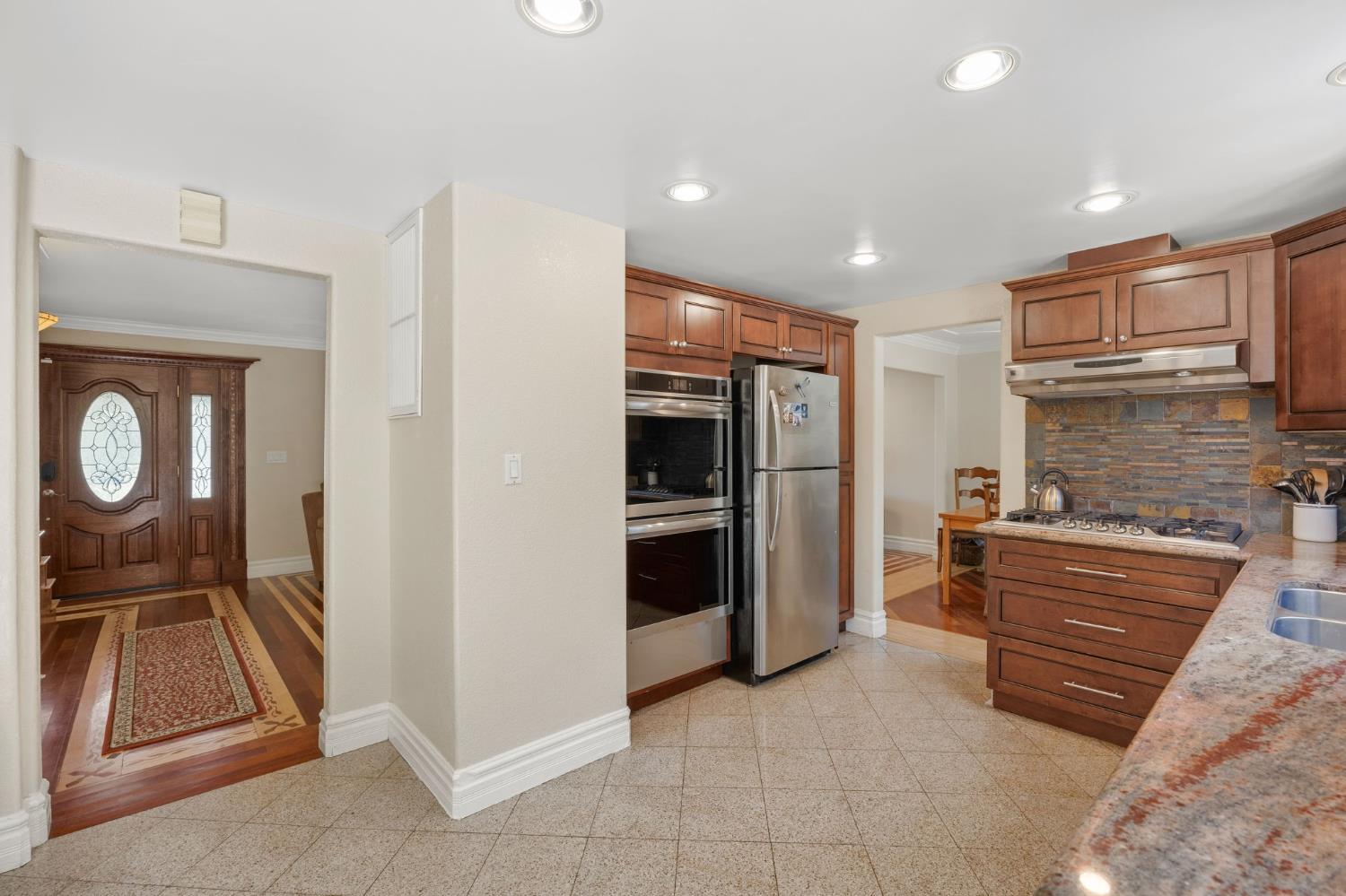 4206 Zephyr Way Sacramento, CA 95821 - Photo 14 of 45 a kitchen with stainless steel appliances granite countertop a refrigerator and a sink