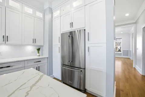 a kitchen with stainless steel appliances a refrigerator sink and cabinets