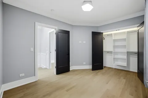 a view of a room with wooden floor and white walls