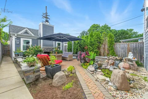 a patio with sofas fire pit table and chairs
