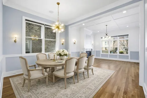 a view of a dining room with furniture wooden floor and chandelier