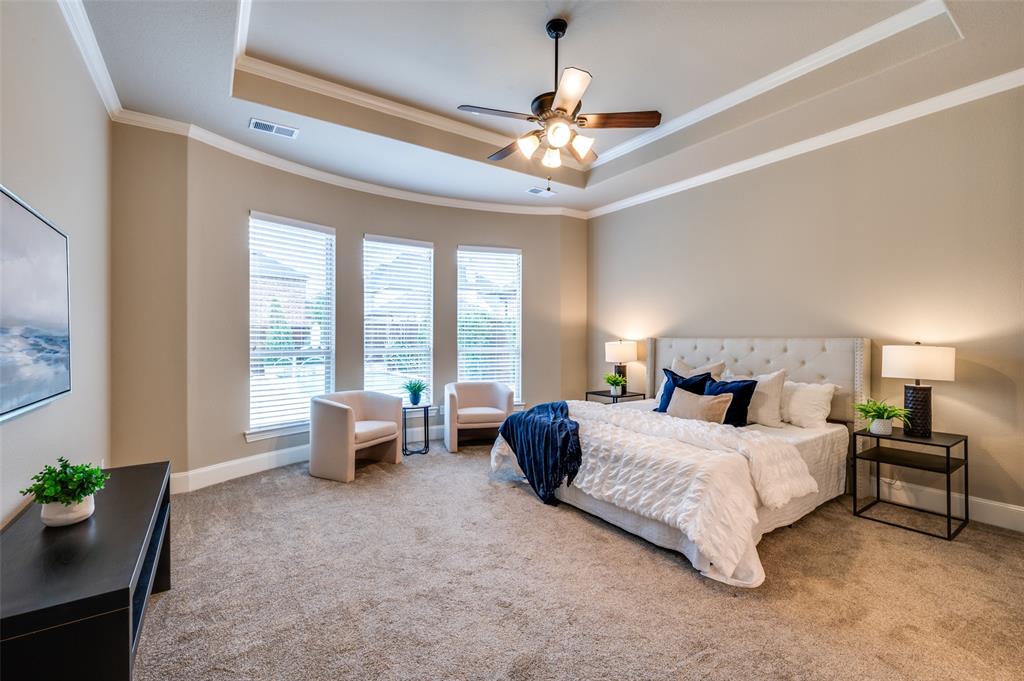 2168 Dampton Drive Frisco, TX 75033 - Photo 13 of 31 a spacious bedroom with a bed and a chandelier