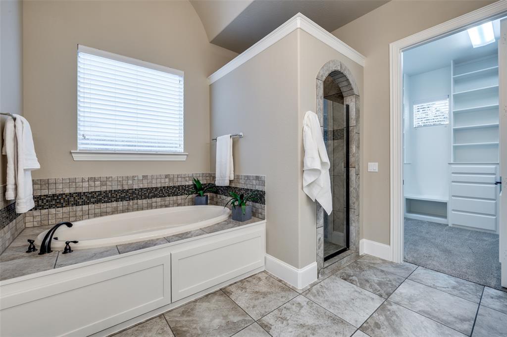 2168 Dampton Drive Frisco, TX 75033 - Photo 15 of 31 a bathroom with a tub a sink and a window