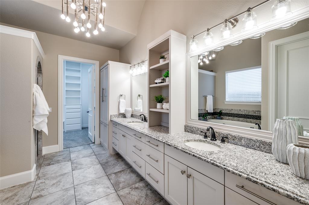 2168 Dampton Drive Frisco, TX 75033 - Photo 16 of 31 a bathroom with a granite countertop double vanity sink a mirror and a shower