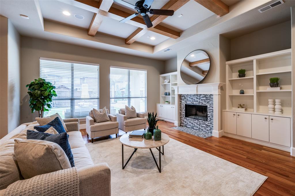2168 Dampton Drive Frisco, TX 75033 - Photo 3 of 31 a living room with furniture a fireplace and a flat screen tv