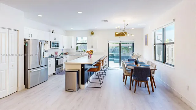 a dining room with furniture a window and wooden floor
