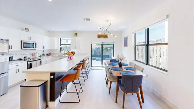 a dining room with furniture and a large window