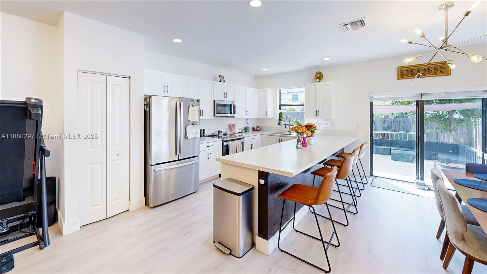 24902 Southwest 107th Avenue Homestead, FL 33032 - Photo 18 of 73 a kitchen with stainless steel appliances refrigerator dining table and chairs