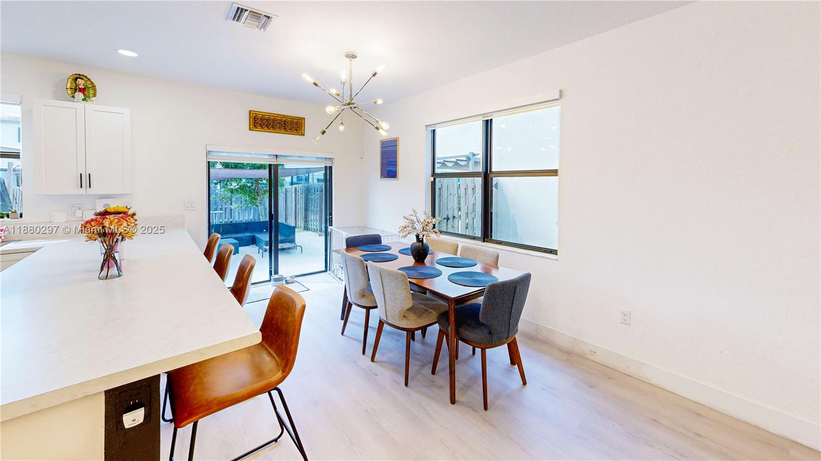 24902 Southwest 107th Avenue Homestead, FL 33032 - Photo 20 of 73 a dining room with furniture a window and wooden floor