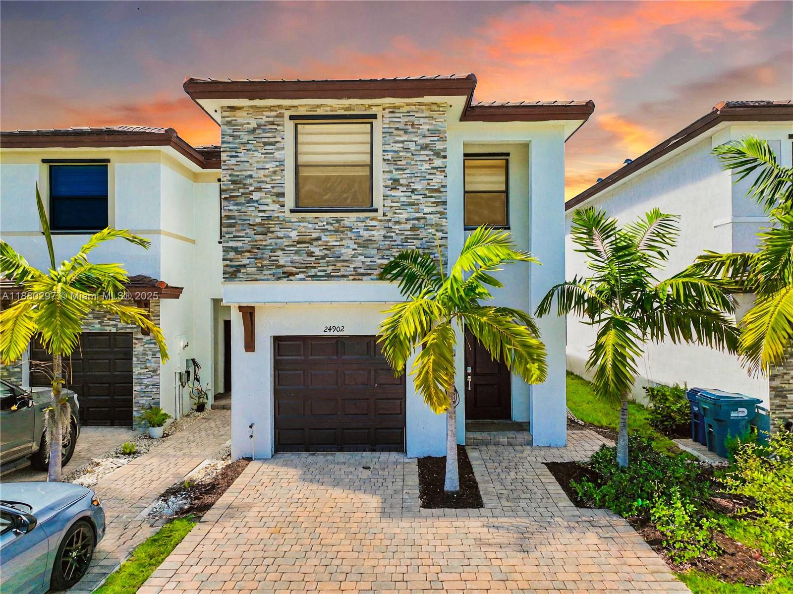 24902 Southwest 107th Avenue Homestead, FL 33032 - Photo 2 of 73 a front view of the house with potted plants