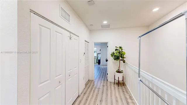 a view of room with wooden floor and ceiling fan