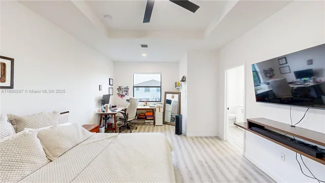 a bedroom with a bed and a flat screen tv