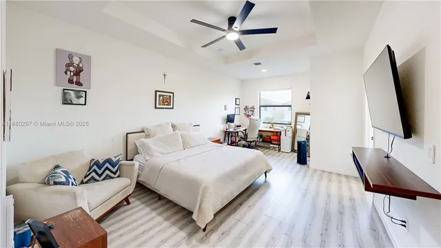 a view of a room with wooden floor and a bathroom