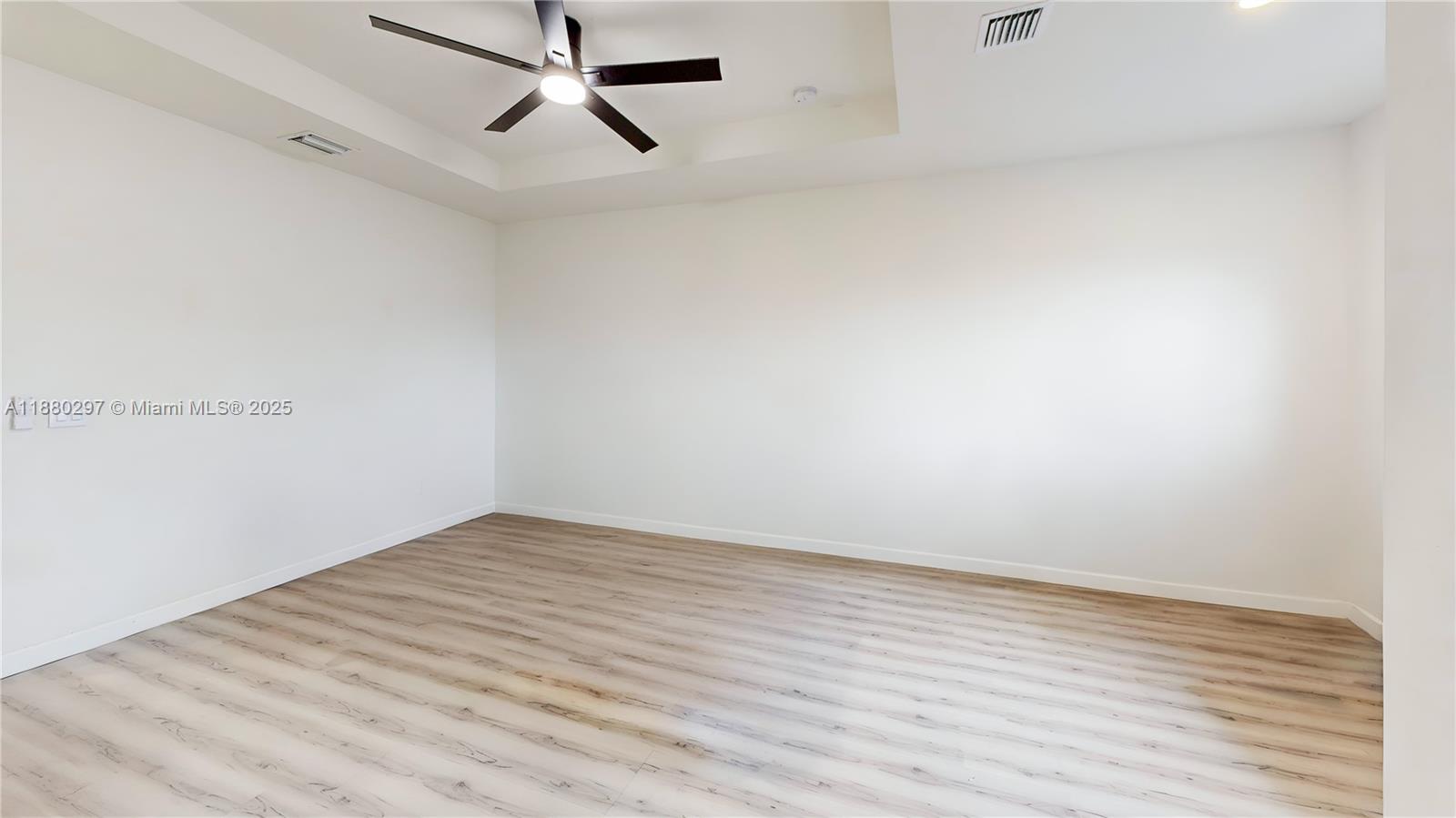 24902 Southwest 107th Avenue Homestead, FL 33032 - Photo 28 of 73 a view of room with wooden floor and ceiling fan