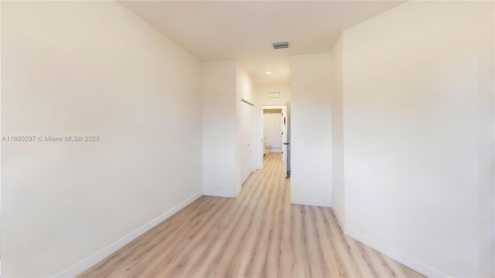24902 Southwest 107th Avenue Homestead, FL 33032 - Photo 30 of 73 a view of a room with wooden floor and a bathroom