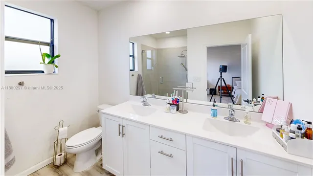 a cabinet with painting on the wall and a refrigerator