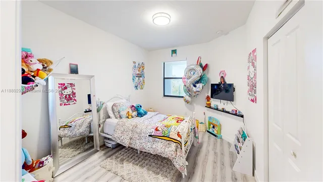 a bathroom with a sink a toilet a mirror and shower