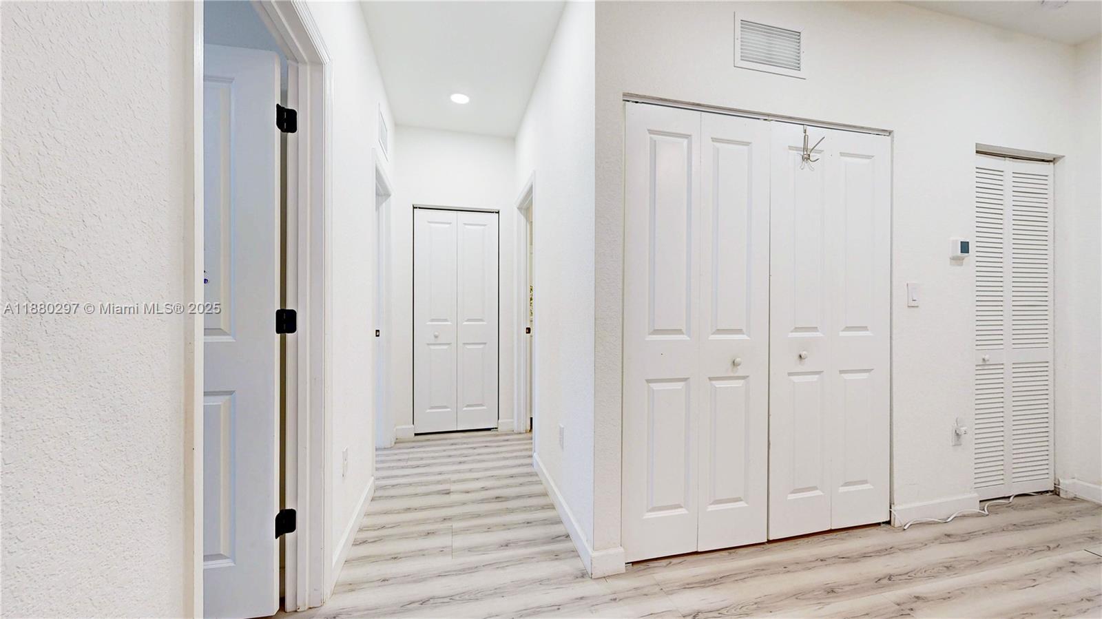 24902 Southwest 107th Avenue Homestead, FL 33032 - Photo 40 of 73 a view of a hallway with wooden floor
