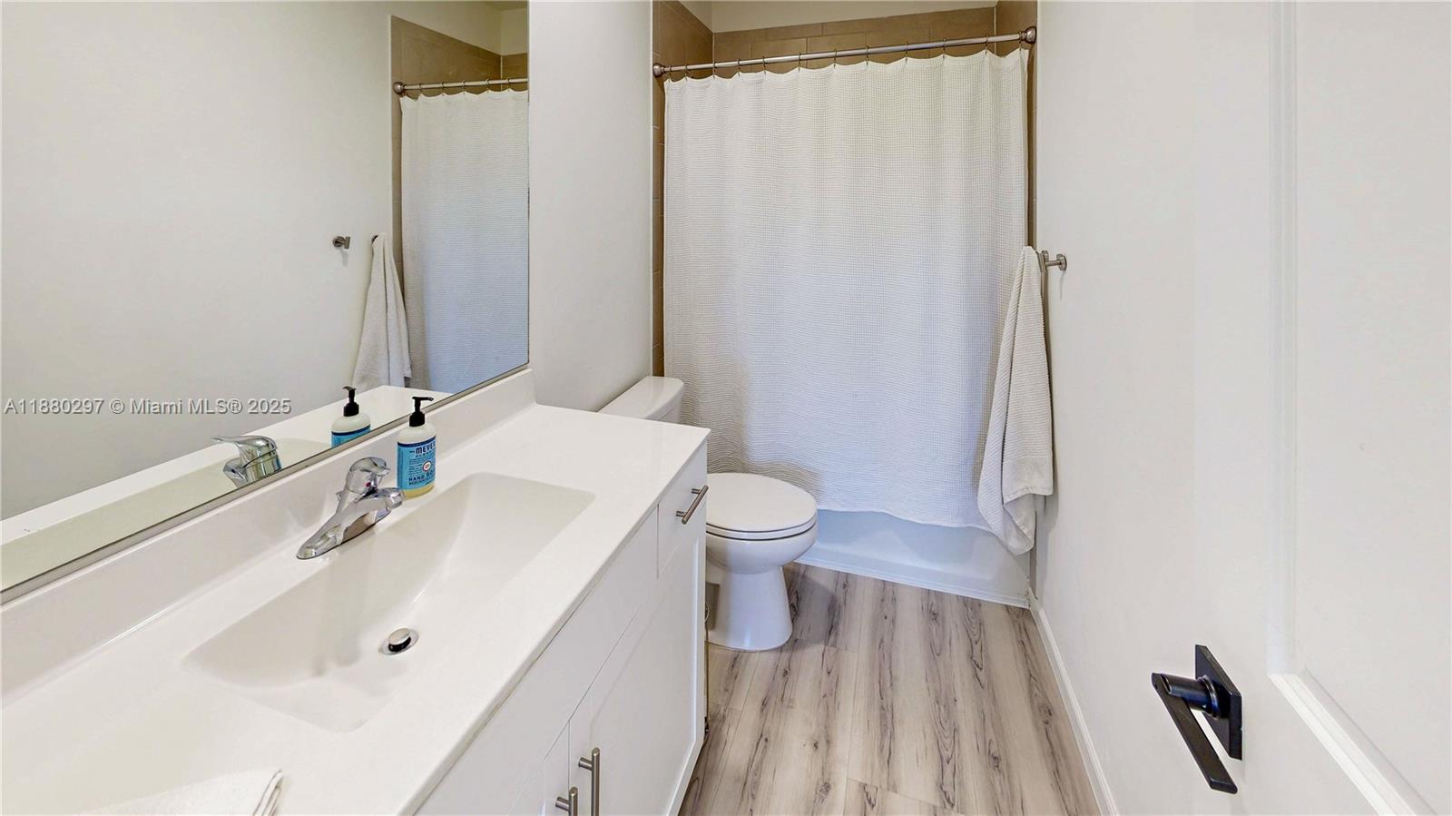24902 Southwest 107th Avenue Homestead, FL 33032 - Photo 41 of 73 a bathroom with a sink a toilet a mirror and shower