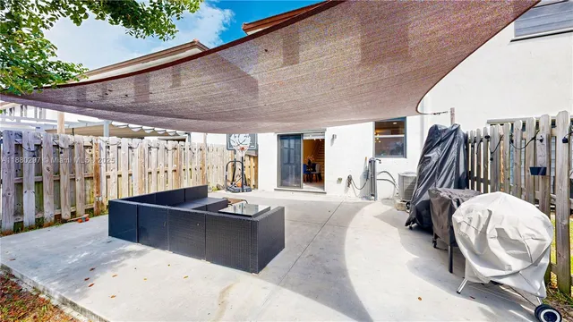 an aerial view of a house with a garden and swimming pool