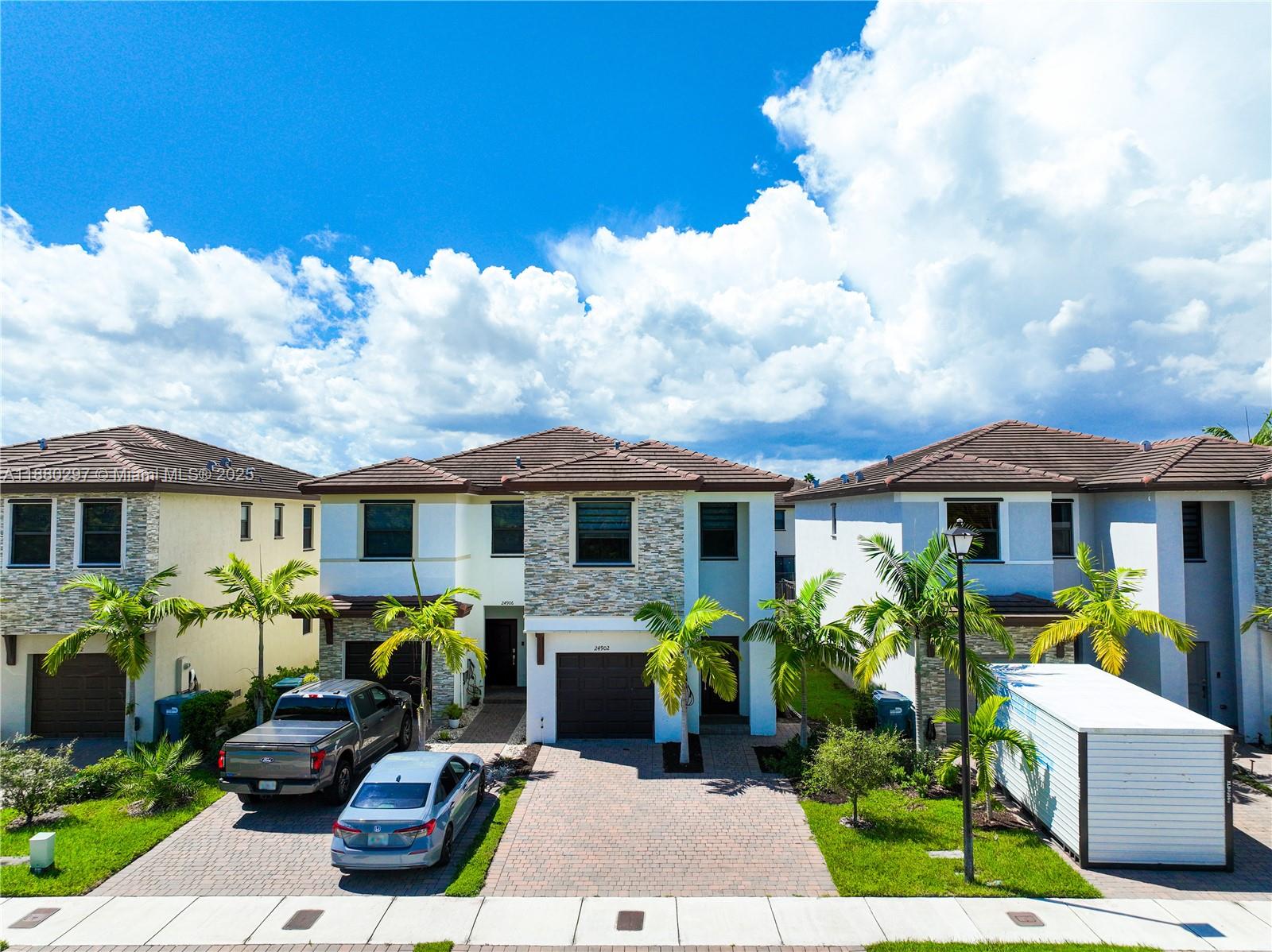 24902 Southwest 107th Avenue Homestead, FL 33032 - Photo 54 of 73 a front view of a house with patio furniture and potted plants