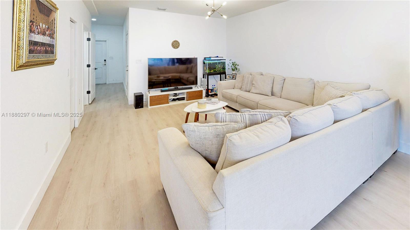 24902 Southwest 107th Avenue Homestead, FL 33032 - Photo 8 of 73 a living room with furniture and a flat screen tv