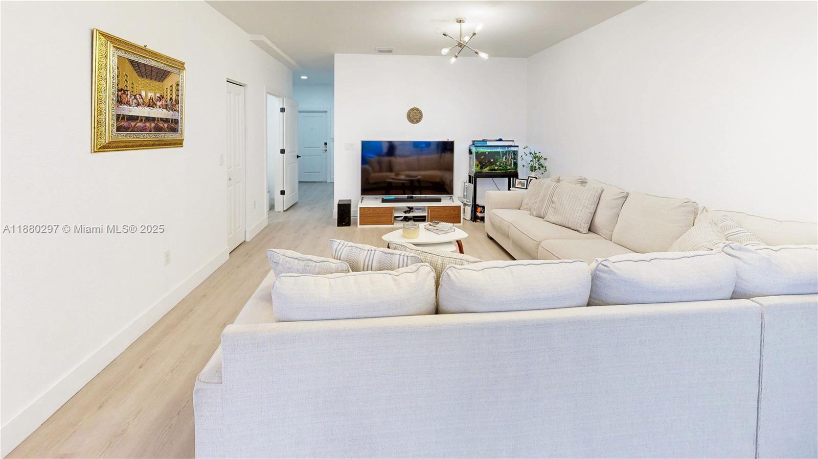 24902 Southwest 107th Avenue Homestead, FL 33032 - Photo 9 of 73 a living room with furniture and a flat screen tv