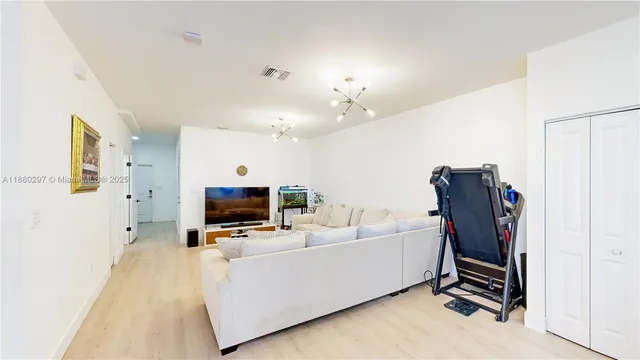 a kitchen with a refrigerator a stove and a dining table