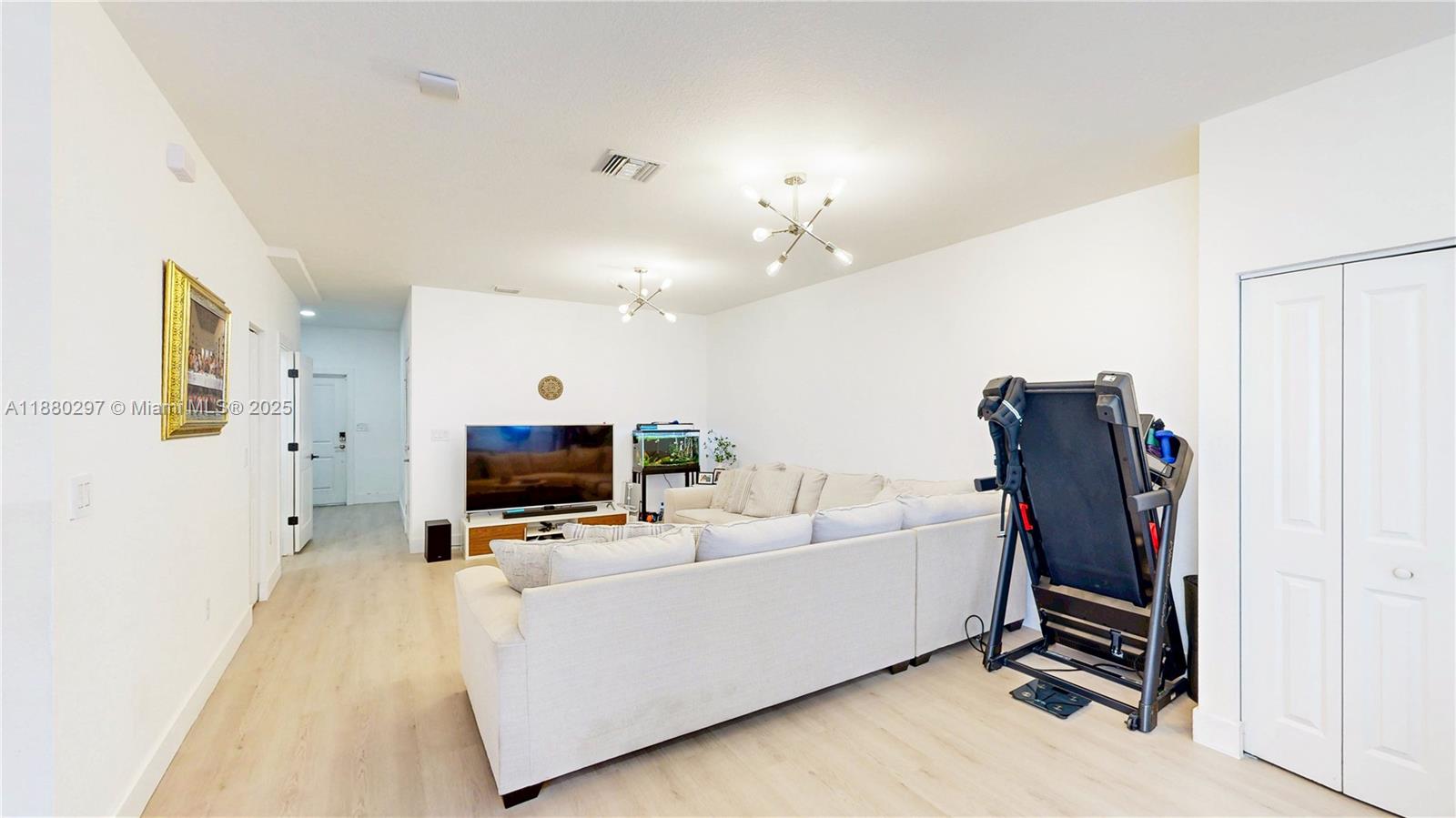 24902 Southwest 107th Avenue Homestead, FL 33032 - Photo 10 of 73 a living room with furniture and a flat screen tv