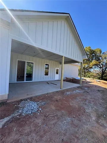 a view of a house with a backyard and garage