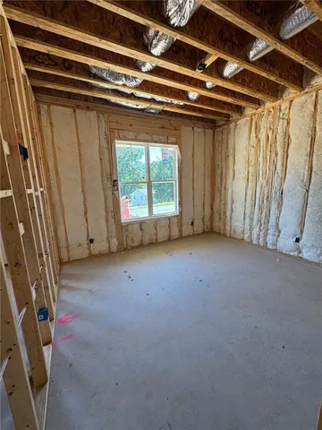 a view of empty room with wooden walls
