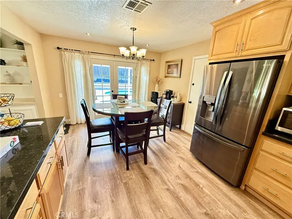 a kitchen with granite countertop stainless steel appliances a refrigerator stove top oven and sink