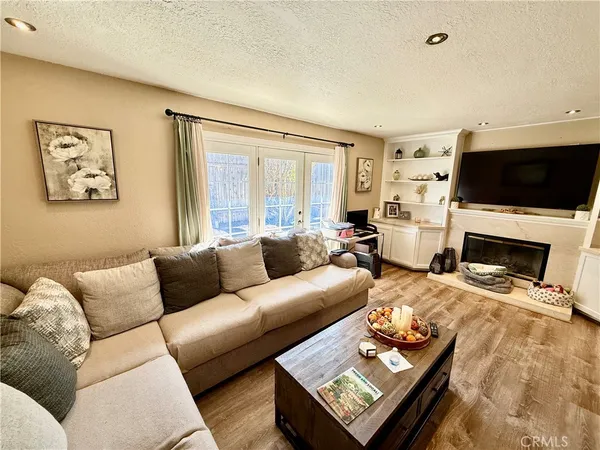 a living room with furniture fireplace and a window
