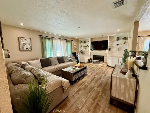a bedroom with a bed and a flat tv screen on the dresser