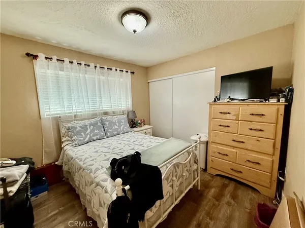 a bed room with a bed and a television