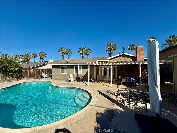 a view of a house with swimming pool and sitting area